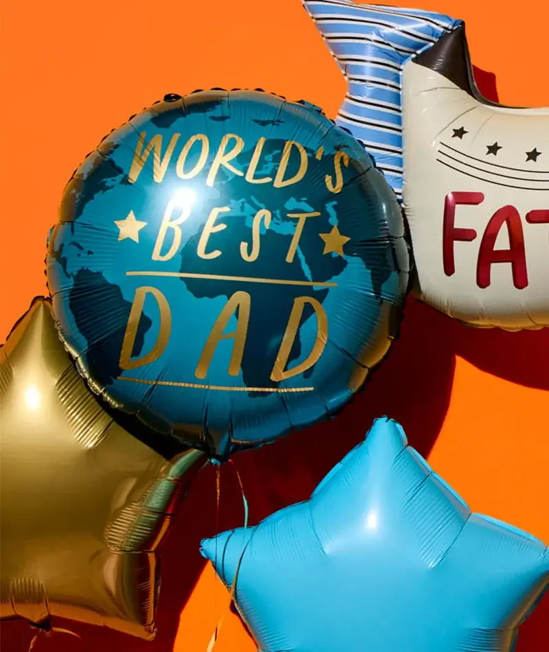 Blue and gold star-shaped balloons with a central balloon reading Worlds Best Dad on a bright orange background